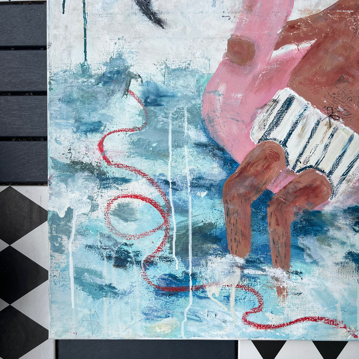 A close-up of a colorful painting featuring a pink flamingo, blue water-like textures, and a black-and-white checkered surface beneath it.