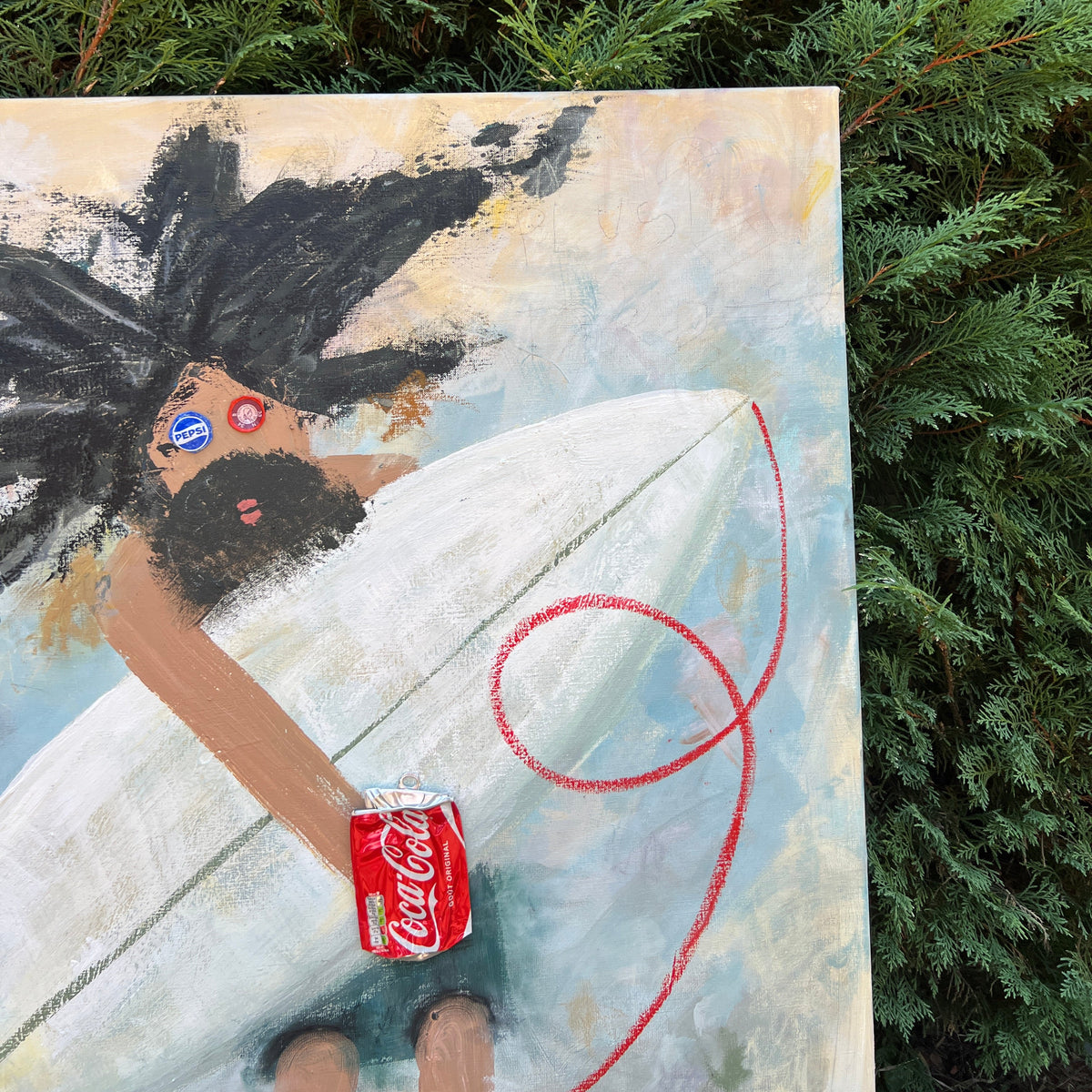 A square canvas painting depicting a woman with dark hair holding a surfboard and a small Coca-Cola can, placed outdoors against green evergreen foliage. The painting includes a red string detail.