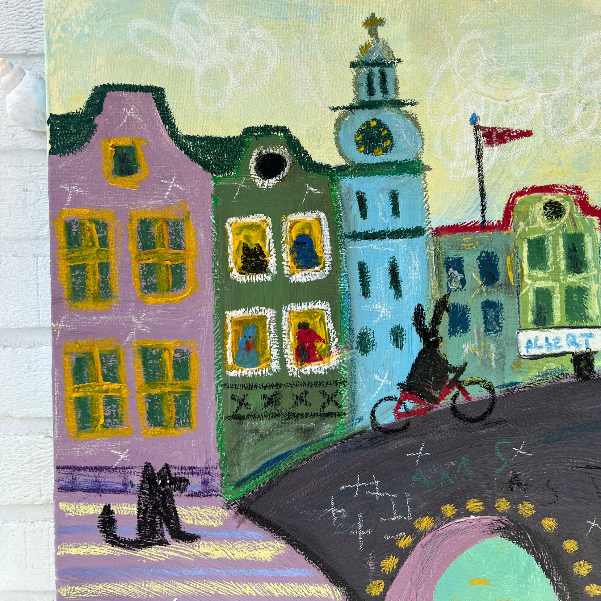 Colorful rug with a stylized cityscape design on a textured surface.