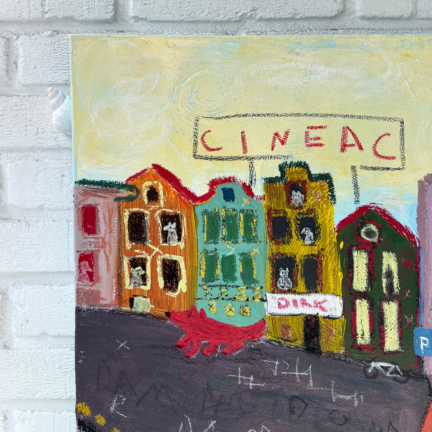 Colorful textured artwork on a white brick wall