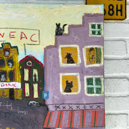 Textile art piece with colorful patterns and a street sign in the background